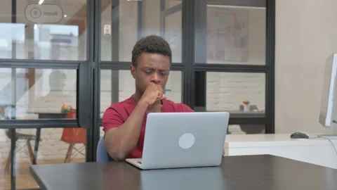 Coughing Casual African Man Typing on Laptop at Workplace Stock Footage 303214853