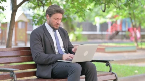 Coughing Middle Aged Businessman Using Laptop Outdoor Stock Footage 313588684