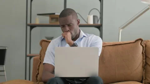 Coughing Sick African Man Using Laptop at Home Stock Footage 287917629