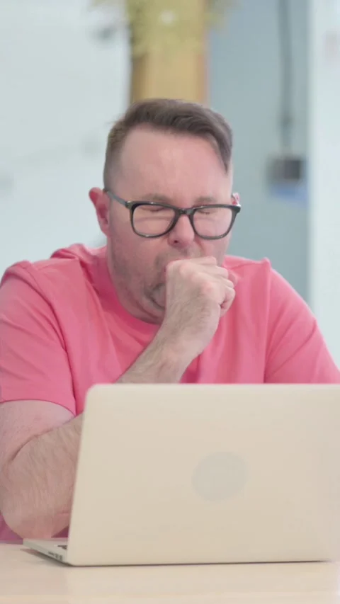 Coughing Sick Man Working on Laptop, vertical video Vídeos de archivo 329105605