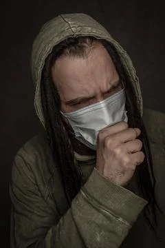 Coughing young man in mask Stock Photos