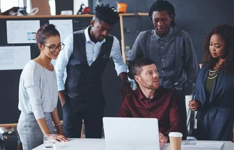 Could you repeat that. a group of creative businesspeople meeting in their Stock Photos