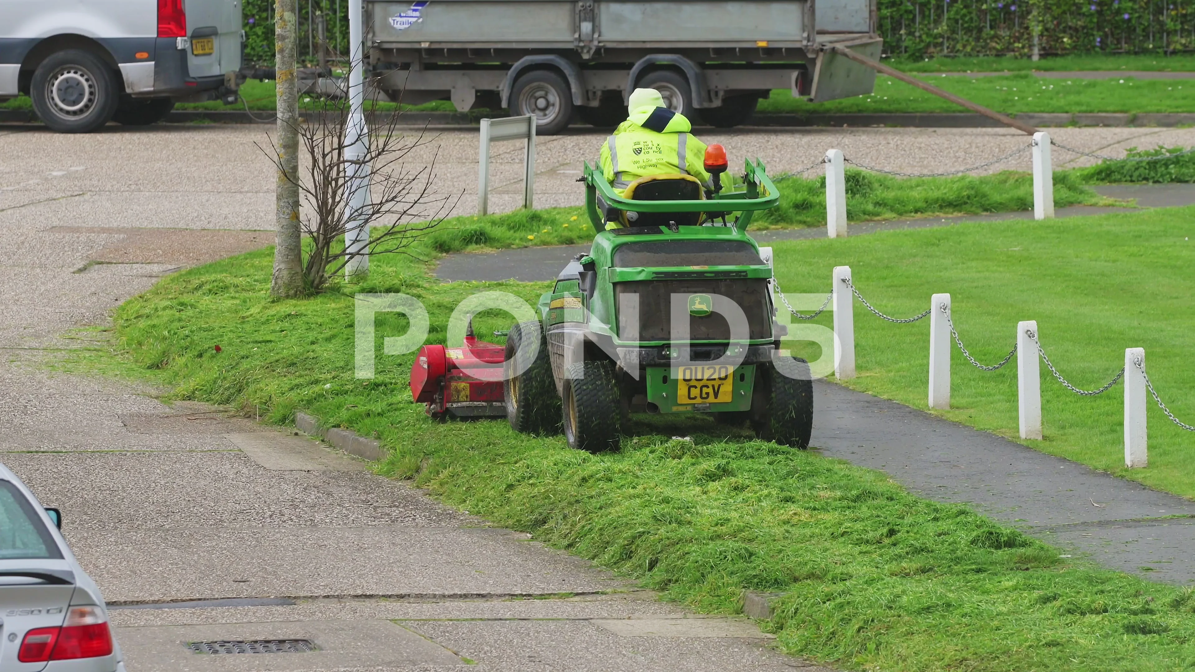 Council worker mowing or cutting grass Stock Video Pond5