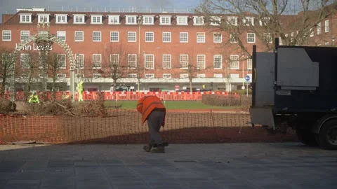 Council worker in orange jacket is cleaning the newly built square Video stock 170595198