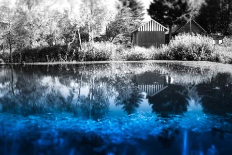 Counrtyside lake with dramatic reflections background Stock Photos