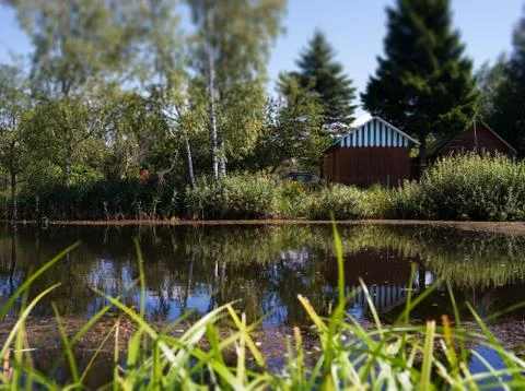 Counrtyside pond with dramatic reflections background Foto stock