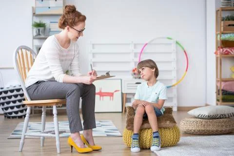 Counselor analyzing autistic boy Stock Photos