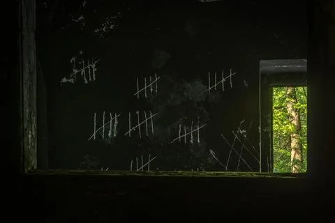 Count days by drawing lines on the wall and scratching off. Stock Photos