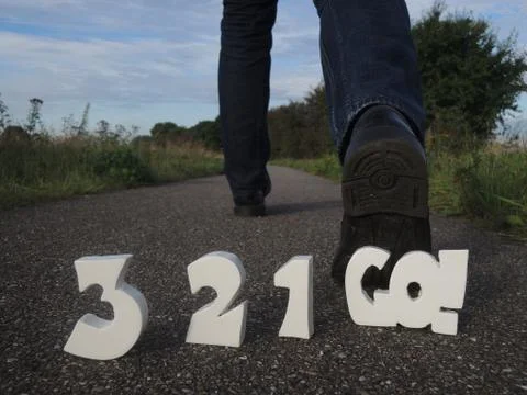 Countdown 3-2-1-go! behind man walking away Stock Photos