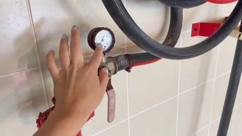 Counter, barometer on a pipe to which the hand reaches to check the readings. Th Stock Footage 282729873