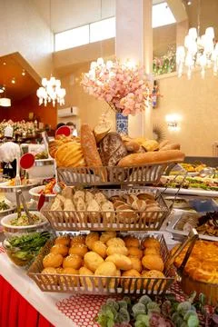 A counter with bread products on a buffet table in a restaurant Stock Photos