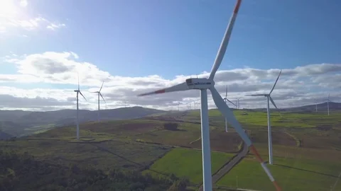 Counter clockwise orbit close beside turbine in wind farm Stock Footage 84366374