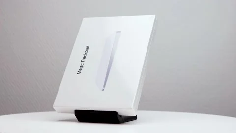 Counter clockwise rotating shiny white package box of Mac magic trackpad Stock Footage 176445539