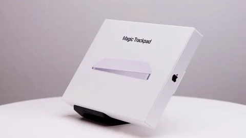 Counter clockwise rotation of white package box of Mac magic trackpad on Stock Footage 174712537