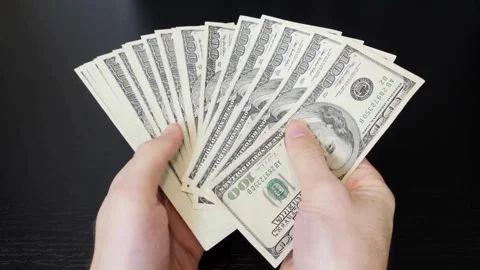 Counting American banknotes on a black background. A man is counting dollar.. Stock Footage 266469713