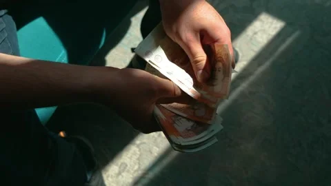 Counting British banknotes pension by elderly unrecognizable man. Handling Stock Footage 316598288