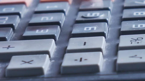 Counting on calculator.  Finger presses the button calculator Stock Footage 63973692