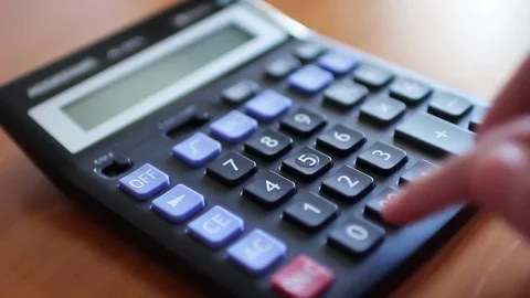 Counting on calculator. Finger presses the button calculator Stock Footage 75963887