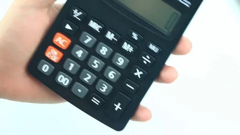 Counting on calculator. Finger presses the button calculator. Closeup. Stock Footage 85026835