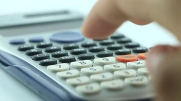 Counting on calculator. Finger presses the button calculator. Closeup. Stock Footage 85564098