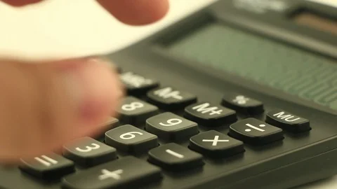 Counting on calculator. Finger presses the button calculator. Closeup. Stock Footage 87259722