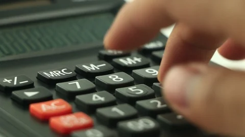 Counting on calculator. Finger presses the button calculator. Closeup. Stock Footage 87259827