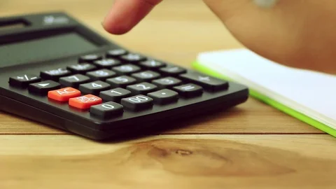 Counting on calculator. Finger presses the button calculator. Closeup. Stock Footage 88706867