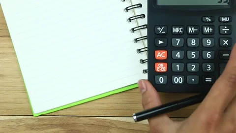 Counting on calculator. Finger presses the button calculator. Closeup. Stock Footage 88707149