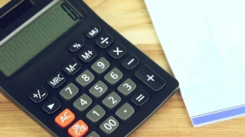 Counting on calculator. Finger presses the button calculator. Closeup. Stock Footage 88707194