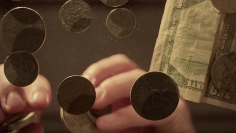 Counting coins and bills from a low angle on the table Stock Footage 319965397