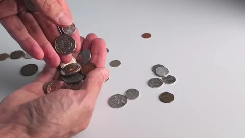 Counting coins and sorting different types of money on a table in a simple way Stock Footage 338120868