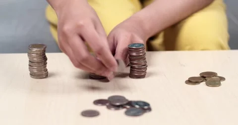 Counting coins a financial learning activity for kids in a home environment Stock Footage 334157498