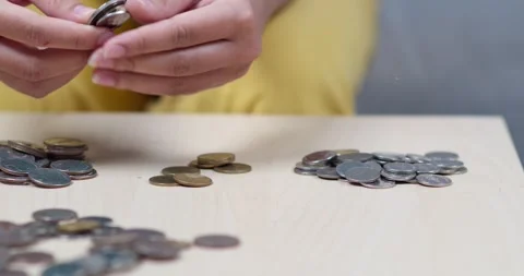 Counting coins home office sequence peaceful setting close-up financial Stock Footage 334217313