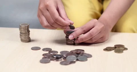 Counting coins personal finance activity home office tutorial indoor close-up Stock Footage 335218972