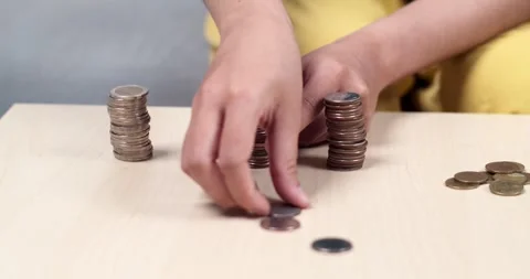 Counting coins a thoughtful process home office action sequence minimalist Stock Footage 335219138