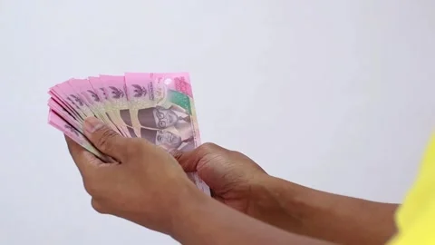Counting Currency Notes Against Plain Background Stock Footage 307048477