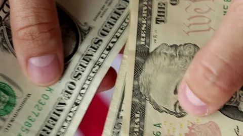 Counting dollars with flag close Video stock 76718876