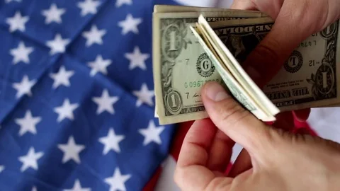 Counting dollars with flag Stock-Footage 76718837