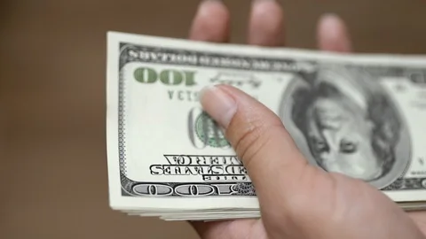 Counting dollars in hands on a light background Stock Footage 85677610
