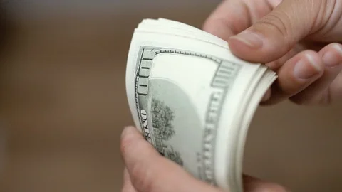 Counting dollars in hands on a light background Vídeo Stock 85677848