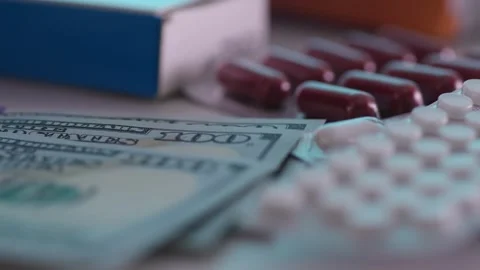 Counting dollars next to medicines and pills. Stock Footage 262604226