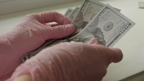 Counting dollars wearing gloves. Close up Stock Footage 127576153