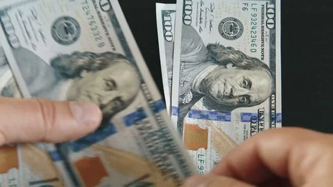 Counting hundred dollar bills Stock Footage