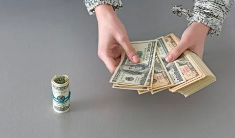 Counting large stack of cash notes Stock Photos