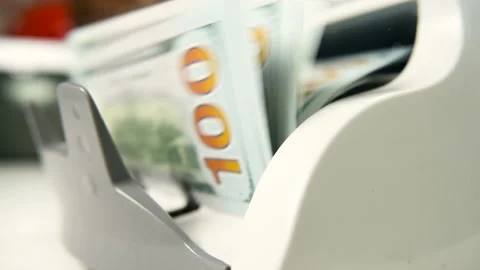 The counting machine counts many bills for one hundred American dollars of a new Stock-Footage 103479809