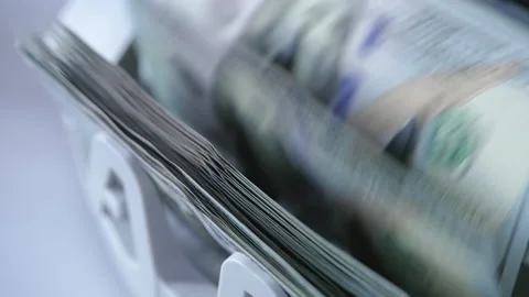 Counting mechanism processing one hundred dollar bills.  Stock Footage 217376365
