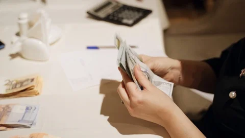 Counting money on the table. Hands of people. dollars and belorussian rubles Stock Footage 125757182