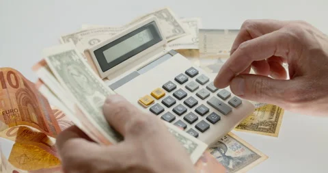 Counting money using old calculator, handeling international paper currency Stock Footage 132284310