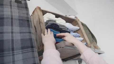 Counting pairs of different coloured thick socks. Retail stock control Stock Footage 250522232