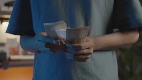Counting Pakistani Currency Notes by Hand Stock Footage 337736662